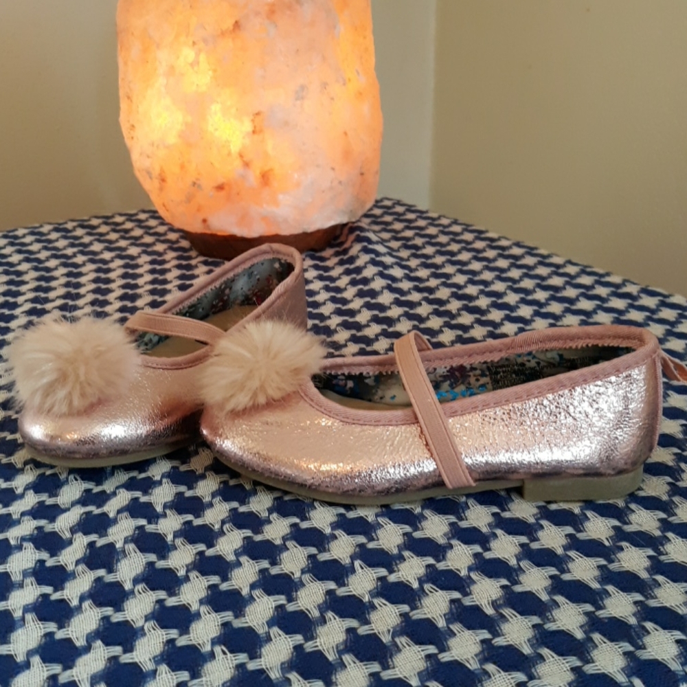 Shiny pink mary janes with pom poms